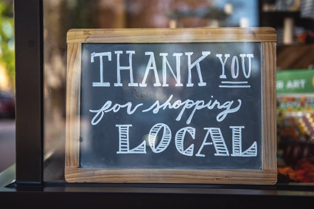 Chalkboard sign encourages shopping local in San Luis Obispo store.